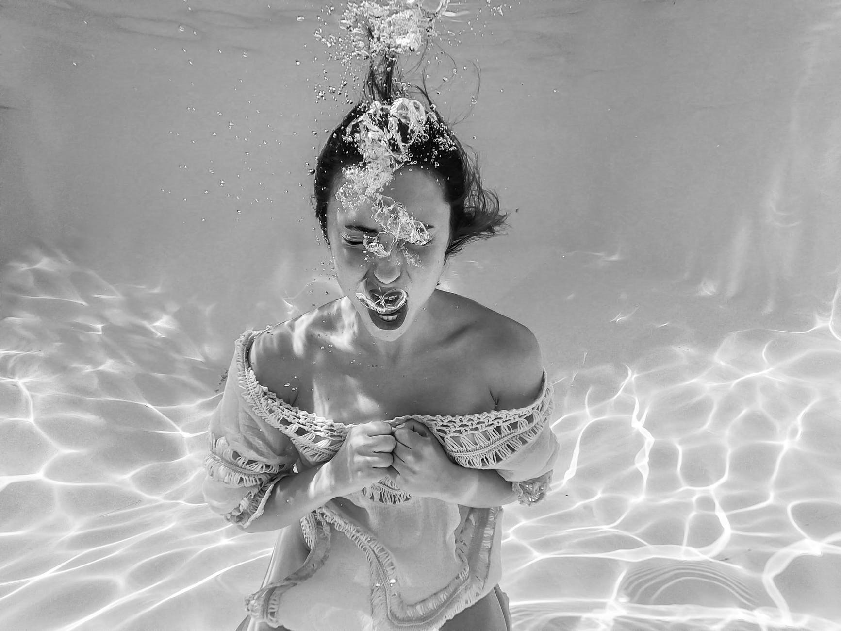anonymous woman screaming underwater
